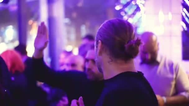Gray haired German man dances with party people at night club weekend event. — Stock Video