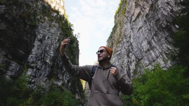 Viajante com smartphone transmitindo sua viagem de montanha nas mídias sociais. — Vídeo de Stock