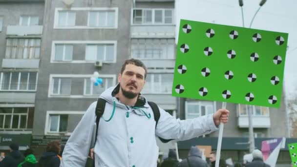 Male protester portrait. Greenscreen chromakey banner at political demonstration — Stock Video