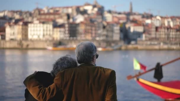 Famille voyageuse couple de personnes âgées assis au quai de la rivière Duero à Porto. — Video