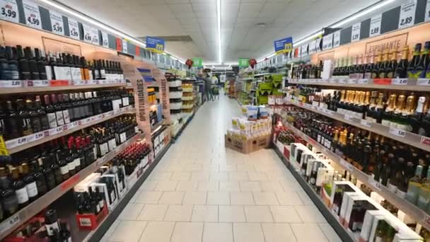 Alkoholos folyosók a szupermarketben. Boros és pezsgős palackok az élelmiszerbolt polcain. — Stock videók