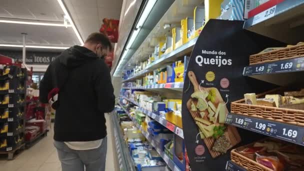 Los hombres compran en el supermercado sin carro. Recogiendo comida de los estantes en el supermercado. — Vídeos de Stock