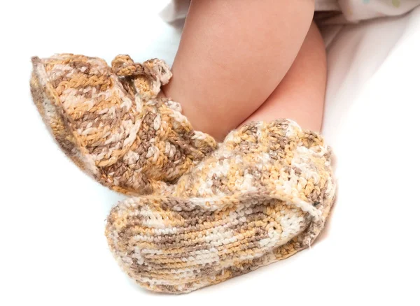 Feet in bootees on white — Stock Photo, Image