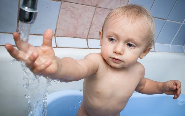 Baby try to touch water Royalty Free Stock Photos