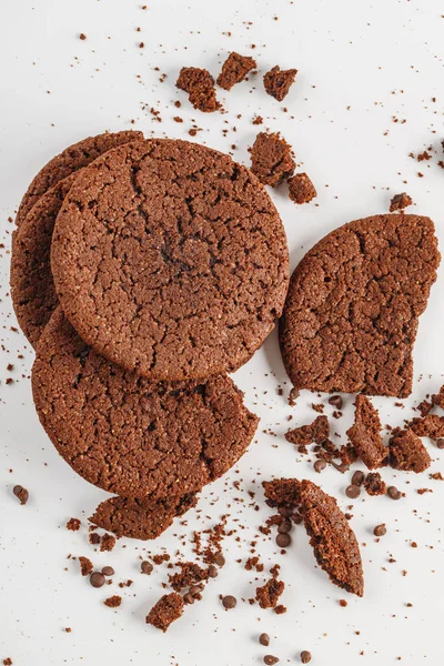 Chocolate american cookies with chocolate chips and raisins on white wooden table. Top view, flat lay