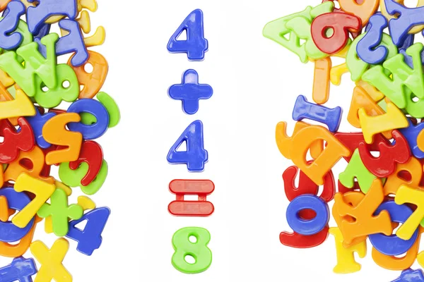 Figuras de plástico cerca de letras de alfabeto plástico —  Fotos de Stock