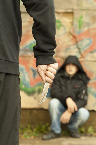 Boy looks at a man with a knife — Stock Photo, Image