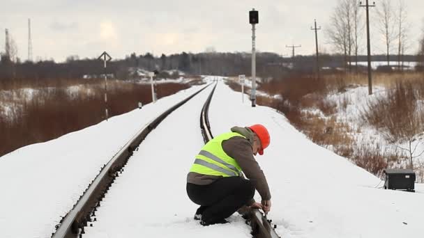 Railroad worker with adjustable wrench fix the nut — Stock Video