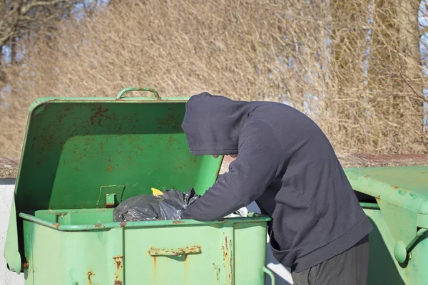 Homeless looking for food in waste containers — Stock Photo, Image