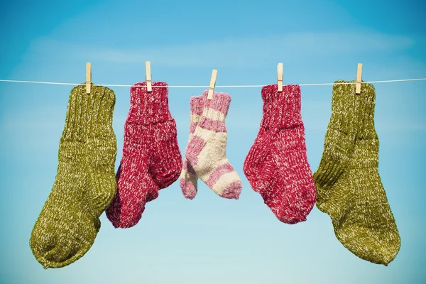 Three pairs of woolen socks hanging on rope — Stock Photo, Image