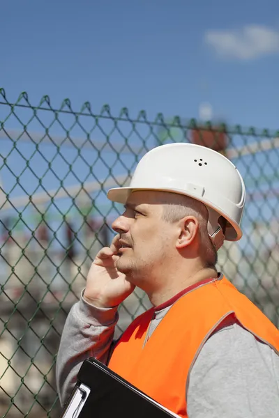 Engineer with a folder in factory site — Stock Photo, Image