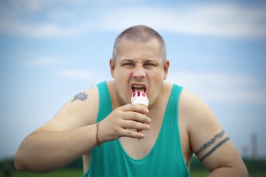 Angry man with ice cream in the hands of clipart
