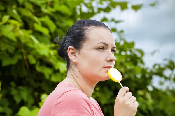 Kvinna med gula lollipop trädgård före stormen — Stockfoto