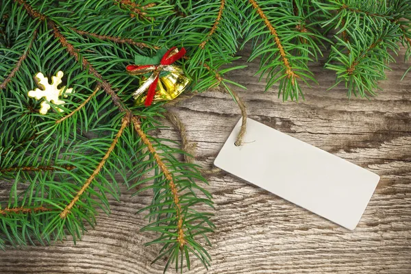 Spruce branches with blank sheet on wood — Stock Photo, Image