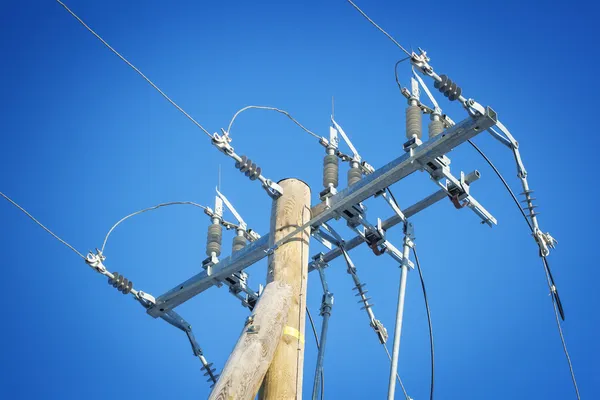 High voltage power divider on a blue sky background — Stock fotografie