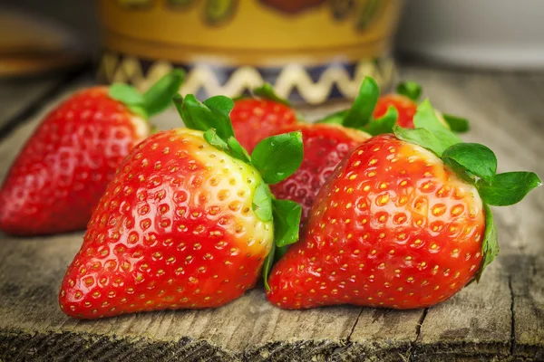 Strawberries on a old wooden table — Stock Photo, Image