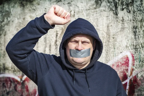 Demonstrator with a tape on a mouth — Stock Photo, Image