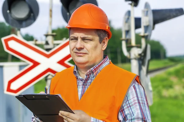 Bahnmitarbeiter mit Ordner in Bahnnähe — Stockfoto