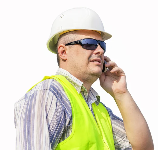 Worker with cell phone on a white background — Stock Photo, Image