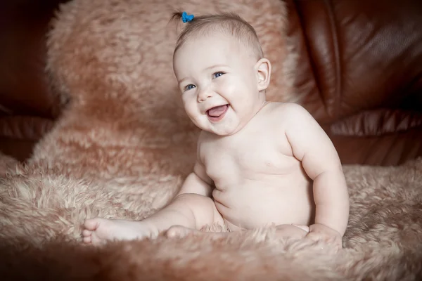 Child sitting on fur — Stock Photo, Image