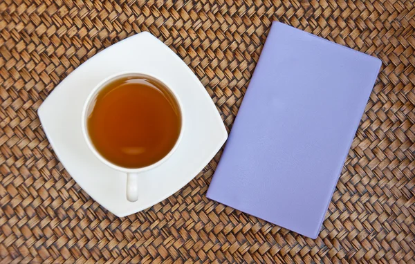 Tea and violet notebook — Stock Photo, Image