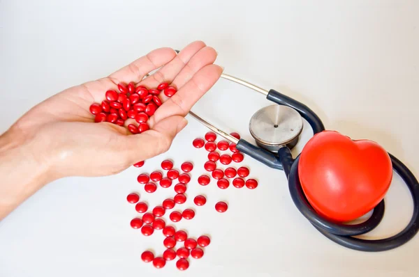 Mano para la píldora roja y vida saludable —  Fotos de Stock
