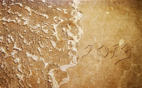 New Year 2013 is coming - numbers written in sand on exotic beachNew Year 2013 is coming - numbers written in sand on exotic beach