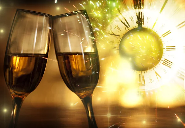 Glasses with champagne against fireworks — Stock Photo, Image