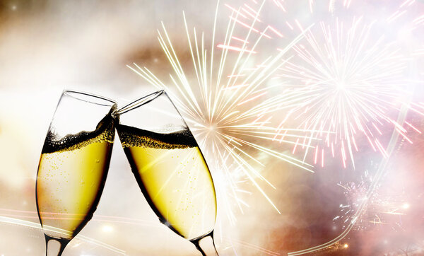 Glasses with champagne against fireworks