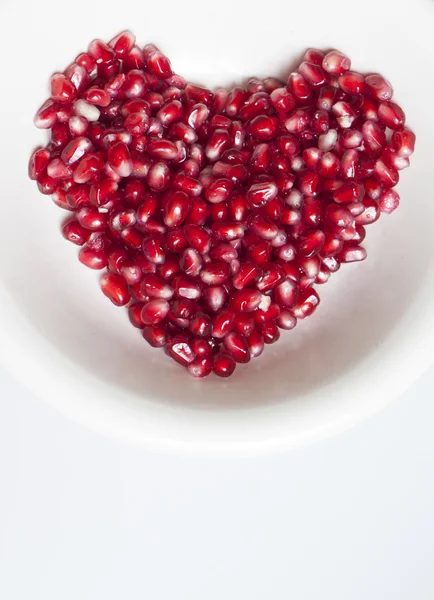 Heart shaped pomegranate seeds — Stock Photo, Image