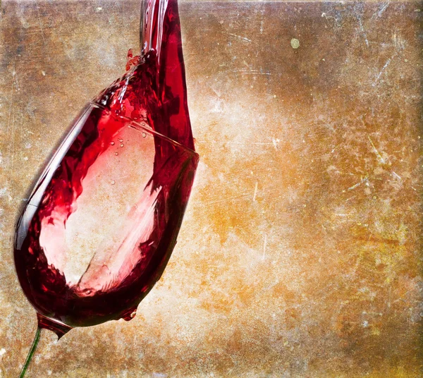 Glass of red wine on vintage background — Stock Photo, Image