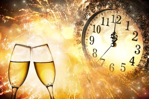 Glasses with champagne and clock close to midnight — Stock Photo, Image