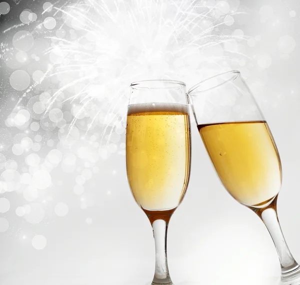 Glasses with champagne against holiday lights — Stock Photo, Image