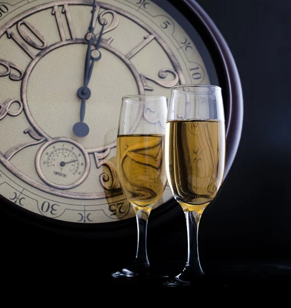 Año Nuevo a medianoche con copas de champán y reloj —  Fotos de Stock