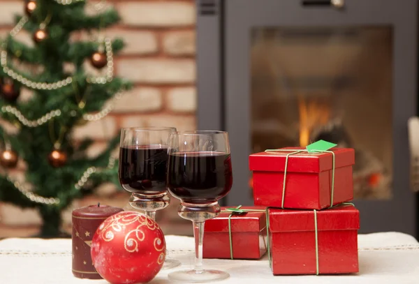 Christmas gift boxes and red wine — Stock Photo, Image