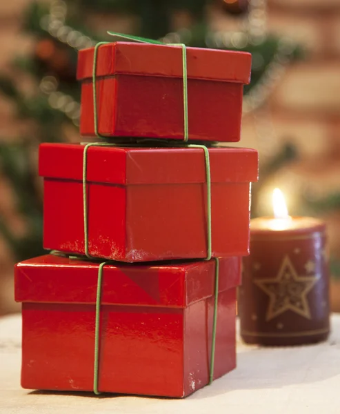 Christmas gift boxes and a candle — Stock Photo, Image