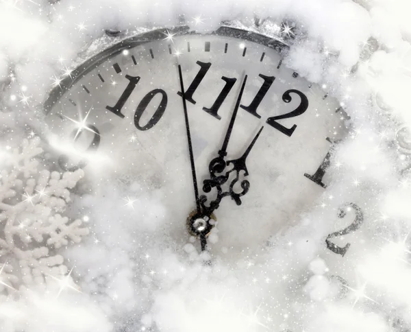Vintage clock covered with snow Royalty Free Stock Photos