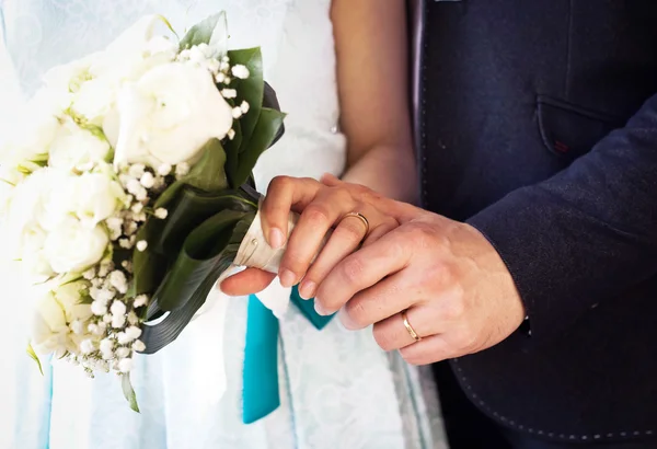 Dłonie i pierścienie na bukiet ślubny — Zdjęcie stockowe