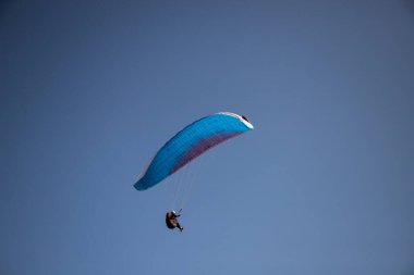 Mavi gökyüzüne karşı yamaç paraşütü Uçan adrenalin ve özgürlük konsepti