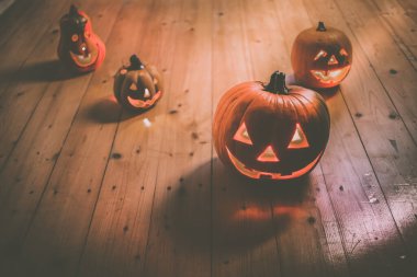 Ürkütücü Jack O 'Lanternler tahta masada Fantezi Gecesinde parlıyor. Cadılar Bayramı Arkaplanı