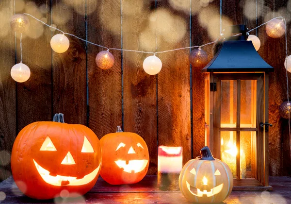 Halloween Jack Lanterns Candles String Lights Wooden Table — стоковое фото