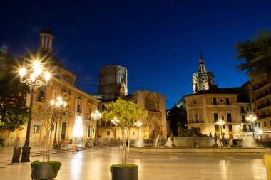VALENCIA , SPAIN - DECEMBER 6, 2021: Square of Saint Mary's with Valencia Cathedral Temple, Basilica de la nuestra senora de los desamparados and the rio tura fountain in old town.