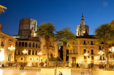 VALENCIA , SPAIN - DECEMBER 6, 2021: Square of Saint Mary's with Valencia Cathedral Temple, Basilica de la nuestra senora de los desamparados and the rio tura fountain in old town.