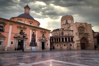 VALENCIA , SPAIN - DECEMBER 6, 2021: Square of Saint Mary's with Valencia Cathedral Temple, Basilica de la nuestra senora de los desamparados and the rio tura fountain in old town.