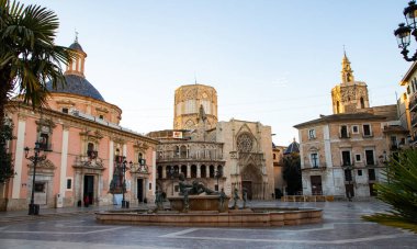 VALENCIA , SPAIN - DECEMBER 6, 2021: Square of Saint Mary's with Valencia Cathedral Temple, Basilica de la nuestra senora de los desamparados and the rio tura fountain in old town.