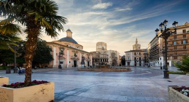 VALENCIA , SPAIN - DECEMBER 6, 2021: Square of Saint Mary's with Valencia Cathedral Temple, Basilica de la nuestra senora de los desamparados and the rio tura fountain in old town.