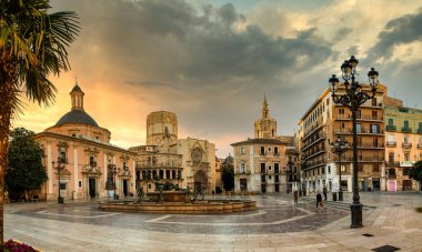 VALENCIA , SPAIN - DECEMBER 6, 2021: Square of Saint Mary's with Valencia Cathedral Temple, Basilica de la nuestra senora de los desamparados and the rio tura fountain in old town.