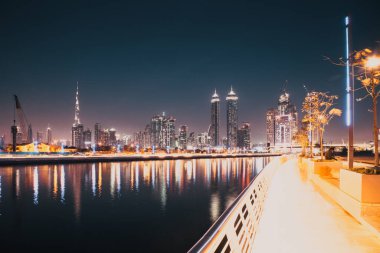 Dubai, Birleşik Arap Emirlikleri - Şubat 2018: Renkli günbatımı Dubai Downtown gökdelenler ve yeni inşa edilen hoşgörü üzerine Dubai su kanalı görüntülendiği şekilde köprü.