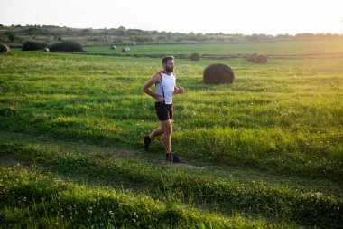 Günbatımında koşan adam sağlıklı aktif yaşam tarzı