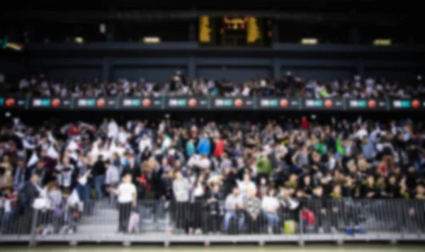 blurred background of supporters at sports event crowd of people in a basketball court